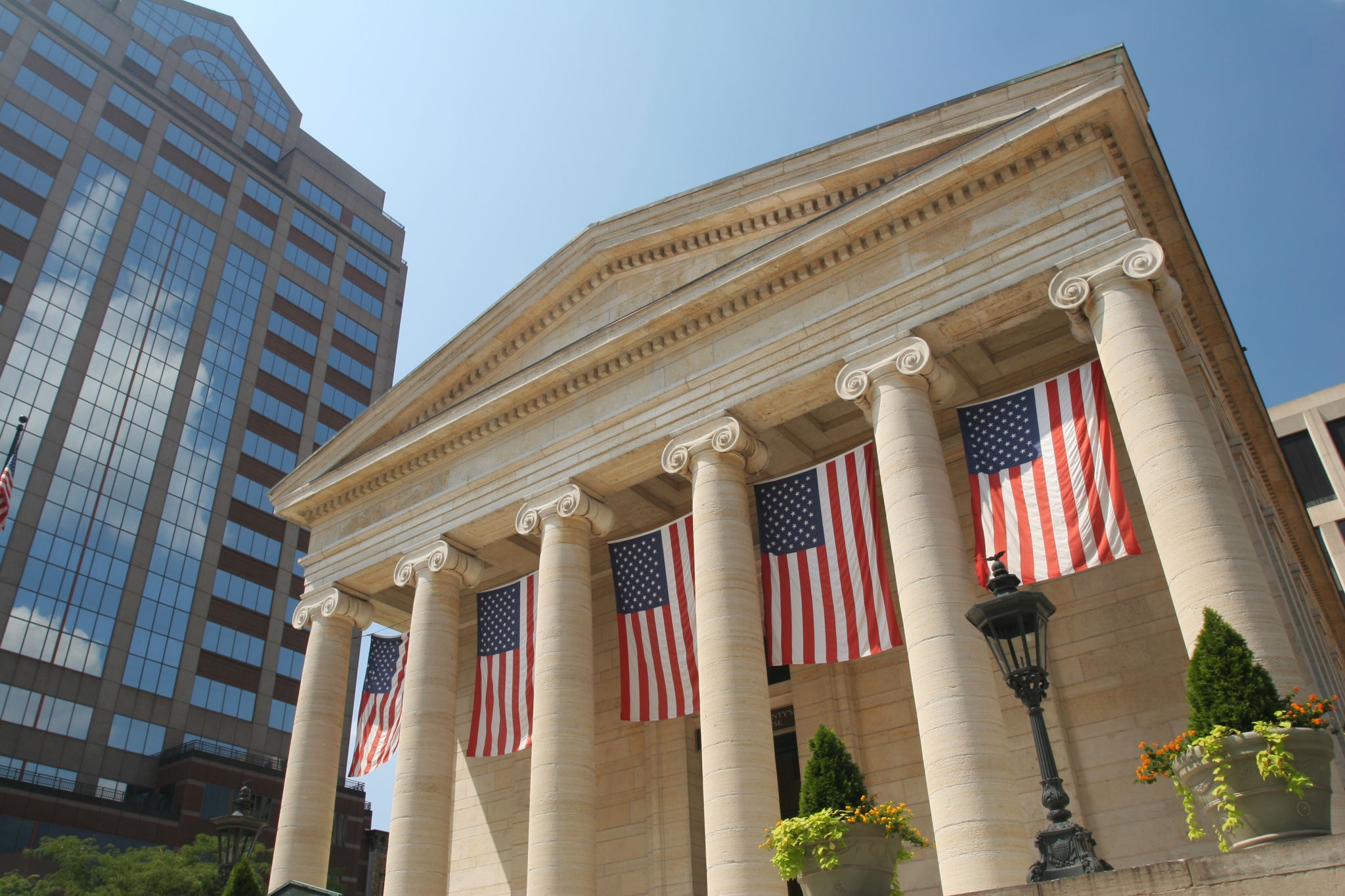 Classical courthouse with American flags — Khemraj Law Firm PC